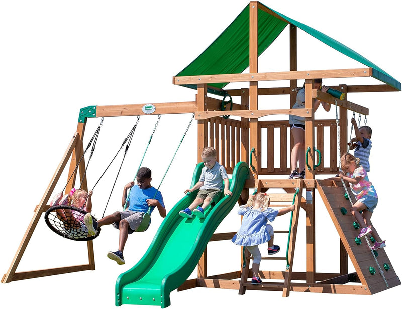 A complete set of wooden mountain-style swings, equipped with a colorful canvas sunshade, a wave slide, a rope swing, a net swing, and a rock wall with climbing ropes and ladders. I2444